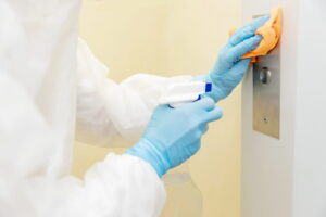 Commercial disinfection services being performed on elevator for virus outbreak protection.
